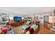 Open living space features a wall mirror reflecting ocean views, a hardwood floor, and modern decor at 988 Blvd Of The Arts # 1016, Sarasota, FL 34236