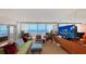 Spacious living room with water views, comfortable seating, and direct access to the balcony at 988 Blvd Of The Arts # 1016, Sarasota, FL 34236