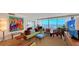 Comfortable living room with bright accents, large windows, and access to the outdoor balcony at 988 Blvd Of The Arts # 1016, Sarasota, FL 34236