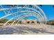 Open-air plaza featuring shaded seating beneath a modern, arched architectural structure, great for events at 988 Blvd Of The Arts # 1016, Sarasota, FL 34236