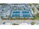Aerial view of tennis courts nestled among palm trees with plenty of parking at 988 Blvd Of The Arts # 1016, Sarasota, FL 34236