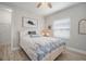 Bright bedroom featuring wood-look floors, ceiling fan, and coastal-themed decor at 10423 Morning Marsh Ln, Parrish, FL 34219