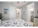 Relaxing bedroom with neutral walls and wood-look floors with an ensuite bathroom at 10423 Morning Marsh Ln, Parrish, FL 34219