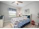 Comfortable bedroom with a window view and wood-look floors, with a calming color palette at 10423 Morning Marsh Ln, Parrish, FL 34219