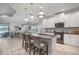Bright, modern kitchen with white cabinets, stainless steel appliances, granite countertops and bar seating at 10423 Morning Marsh Ln, Parrish, FL 34219