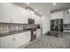 Modern kitchen with white cabinets, granite counters, stainless steel appliances, and tile backsplash at 10423 Morning Marsh Ln, Parrish, FL 34219