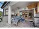 Inviting outdoor living space with summer kitchen, TV, comfortable seating and view through sliding doors to the home's interior at 10423 Morning Marsh Ln, Parrish, FL 34219