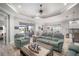 Open-concept living room with tile floors, coastal decor, and view into dining room and kitchen at 10423 Morning Marsh Ln, Parrish, FL 34219