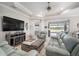 Bright living room featuring tile floors, leather furniture, fireplace, and view of pool at 10423 Morning Marsh Ln, Parrish, FL 34219