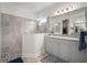 Luxurious main bathroom with a large glass shower and double vanity sinks, offering ample space at 10423 Morning Marsh Ln, Parrish, FL 34219