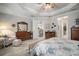 Spacious main bedroom features wood-look floors, tray ceiling, and entry to living spaces at 10423 Morning Marsh Ln, Parrish, FL 34219
