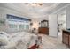 Comfortable main bedroom with decorative tray ceiling, wood-look floors, and a window view at 10423 Morning Marsh Ln, Parrish, FL 34219