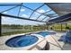 Sparkling pool and spa with scenic lake views and screened-in lanai, perfect for outdoor entertaining and relaxation at 10423 Morning Marsh Ln, Parrish, FL 34219