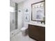 Modern bathroom featuring a glass shower, a wood-trimmed vanity with a white countertop, and modern fixtures at 1198 Blue Shell Loop, Sarasota, FL 34240