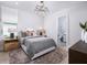 Comfortable bedroom with a queen-sized bed, neutral decor, and a bathroom at 1198 Blue Shell Loop, Sarasota, FL 34240