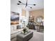 Comfortable living room with an ottoman, neutral-toned walls, unique light fixture, and decoratively arranged shelves at 1198 Blue Shell Loop, Sarasota, FL 34240