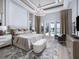 Serene main bedroom featuring a luxurious bed, tray ceiling, and doors to the pool at 1198 Blue Shell Loop, Sarasota, FL 34240