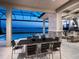 Outdoor dining area with seating, a lake view, and access to the pool, creating a relaxing and inviting space at 1198 Blue Shell Loop, Sarasota, FL 34240