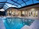 Backyard pool and spa with a screened enclosure, seamlessly blending indoor and outdoor living spaces at 1198 Blue Shell Loop, Sarasota, FL 34240