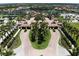 An aerial view of an elaborate residential entrance, lush landscaping and beautiful grounds at 12515 Garibaldi Ln, Venice, FL 34293