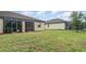 Exterior of home displaying the grassy backyard, perfect for outdoor activities and gatherings at 12515 Garibaldi Ln, Venice, FL 34293