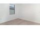 Cozy bedroom with a window and plush neutral carpeting, ready for personalization at 12515 Garibaldi Ln, Venice, FL 34293