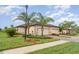 Charming home featuring a barrel tile roof, lush landscaping, and a paver driveway leading to a two-car garage at 12515 Garibaldi Ln, Venice, FL 34293