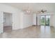 Open concept living space with tile floors, modern lighting, and sliding glass doors leading to outdoor area at 12515 Garibaldi Ln, Venice, FL 34293