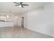 Spacious living room with tile floors, light neutral paint, and view of kitchen and dining area at 12515 Garibaldi Ln, Venice, FL 34293
