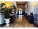 Inviting lobby with travertine floors, elegant lighting, and comfortable seating at 12515 Garibaldi Ln, Venice, FL 34293