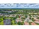 Scenic aerial view of house with pond view and landscaped backyard at 12710 Stone Ridge Pl, Lakewood Ranch, FL 34202