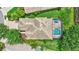Overhead view of a single-Gathering home featuring a tile roof, screened pool, and lush landscaping at 12710 Stone Ridge Pl, Lakewood Ranch, FL 34202