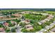 Pictureque aerial view of landscaped home with pond views and mature trees at 12710 Stone Ridge Pl, Lakewood Ranch, FL 34202