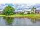 View of the backyard with a screened-in patio, and a pond at 12710 Stone Ridge Pl, Lakewood Ranch, FL 34202