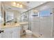 Bright bathroom with walk-in shower, white tiled walls, and an elegant vanity at 12710 Stone Ridge Pl, Lakewood Ranch, FL 34202