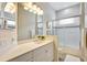 Bright bathroom featuring a shower, single vanity, and frosted glass at 12710 Stone Ridge Pl, Lakewood Ranch, FL 34202
