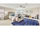 Large bedroom featuring a rug, bed, television, and musical instruments at 12710 Stone Ridge Pl, Lakewood Ranch, FL 34202