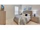 Comfortable bedroom with neutral tones, a tufted headboard, and soft, cozy blankets at 12710 Stone Ridge Pl, Lakewood Ranch, FL 34202