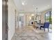 Elegant dining room with tiled floors, fireplace, and large windows offering views of the outdoor scenery at 12710 Stone Ridge Pl, Lakewood Ranch, FL 34202