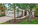 Exterior of the single-story home with well-maintained landscaping and a brick driveway leading to an attached garage at 12710 Stone Ridge Pl, Lakewood Ranch, FL 34202
