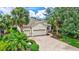 Landscaped front yard and brick driveway leading to the attached three-car garage of a single-story home at 12710 Stone Ridge Pl, Lakewood Ranch, FL 34202
