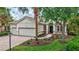 Charming single-story home featuring a well-manicured lawn, brick walkway, and a spacious two-car garage at 12710 Stone Ridge Pl, Lakewood Ranch, FL 34202