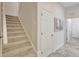 Light-filled hallway with carpeted stairs and a tiled floor at 12710 Stone Ridge Pl, Lakewood Ranch, FL 34202