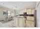 Bright kitchen boasts granite countertops, stainless steel appliances, and an island with tile flooring and a breakfast nook at 12710 Stone Ridge Pl, Lakewood Ranch, FL 34202