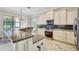 Well-lit kitchen with granite countertops, stainless steel appliances and tiled flooring at 12710 Stone Ridge Pl, Lakewood Ranch, FL 34202