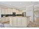 A bright open-concept kitchen features granite countertops, stainless steel appliances, an island, and ample cabinet space at 12710 Stone Ridge Pl, Lakewood Ranch, FL 34202
