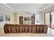 Elegant living room with large sofa, decorative shelving and neutral color palette at 12710 Stone Ridge Pl, Lakewood Ranch, FL 34202
