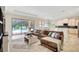 Open living space featuring a comfortable sofa and a view of the pool at 12710 Stone Ridge Pl, Lakewood Ranch, FL 34202