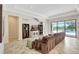 Open-concept living room with tile floors and a view of the screened pool at 12710 Stone Ridge Pl, Lakewood Ranch, FL 34202