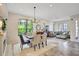 Open floor plan combining dining and living areas, filled with natural light and stylish decor at 12710 Stone Ridge Pl, Lakewood Ranch, FL 34202